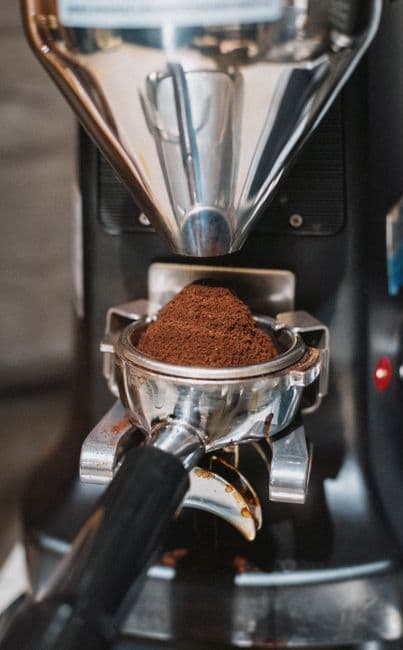 A grinder dosing into the basket